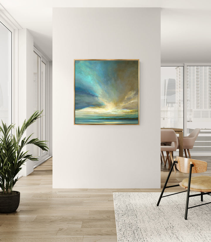 Modern interior with a painting of a sunset over water on a white wall.